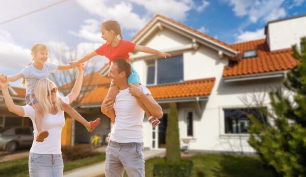 Happy family near new house. Real estate concept