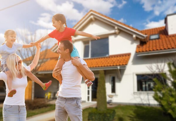 Happy family near new house. Real estate concept